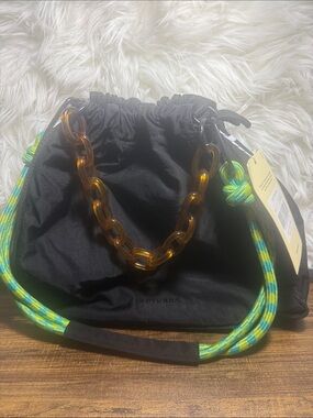 Black Shoulder Drawstring Bag with Amber Chain and Green Accent Rope